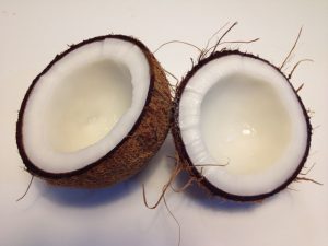 Coconut split in two showing the white meat inside.