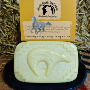Shea-mango and oranges soap handmade zuni bear design surrounded by soap box and hay bale.